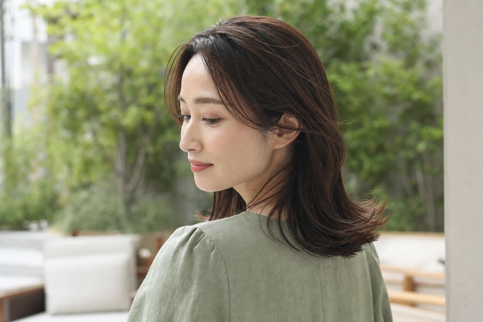 毛先を外ハネにし顔まわりを後方へ流した肩下ダークブラウンセミロングの後方三四分