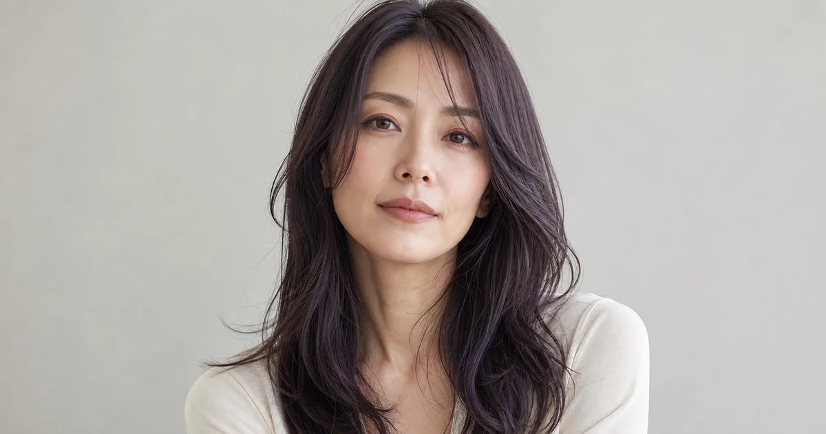暗いバイオレットブルーブラウンのロングヘアを自然光で見せる成人女性